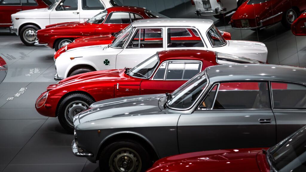 A striking collection of vintage Alfa Romeo cars showcased beautifully in a museum setting.